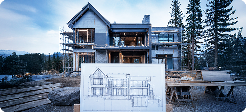 Custom home under construction with architectural plans displayed in front of the house