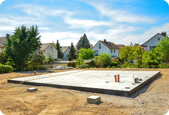 Newly poured concrete foundation slab prepared for a residential home.